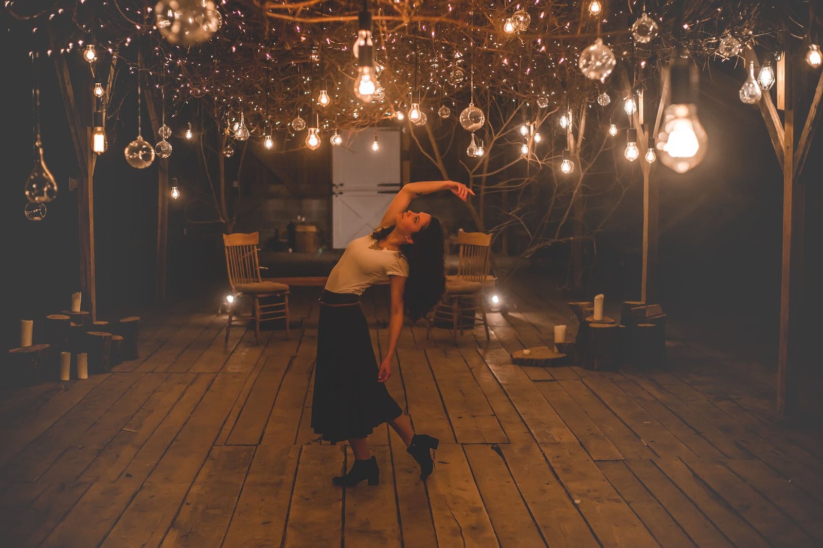 woman dancing on terrace with lights turned on